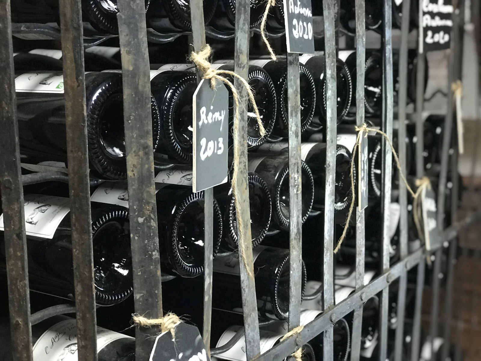 Casier de garde de bouteilles, etiquettes a la craie. Atmospherique.